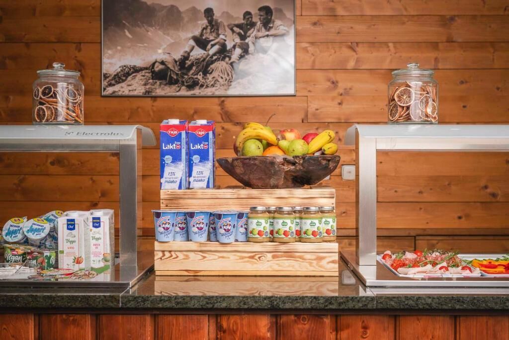 A buffet setup with various food items, including fruits, dairy products, and condiments.