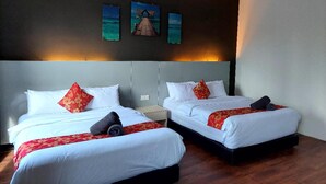 A hotel room with two beds, each with white bedding and red floral pillows. There are three framed pictures on the wall above the beds. - Sakura Elite Hotel (Kuala Lumpur)