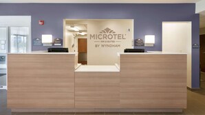 A reception desk with a sign reading "MICROTEL INN & SUITES BY WYNDHAM" and a "MANAGER ON DUTY" sign. - Microtel Inn & Suites By Wyndham Georgetown Delaware Beaches (Georgetown)