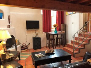 Apartment, 1 Queen Bed | Living room | TV, fireplace - Casas de Guadalupe (Santa Fe)