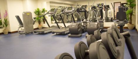 Una palestra con tapis roulant, ellittiche e macchinari per pesi.