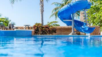 Relax by the pool surrounded by lush greenery and enjoy a refreshing swim.