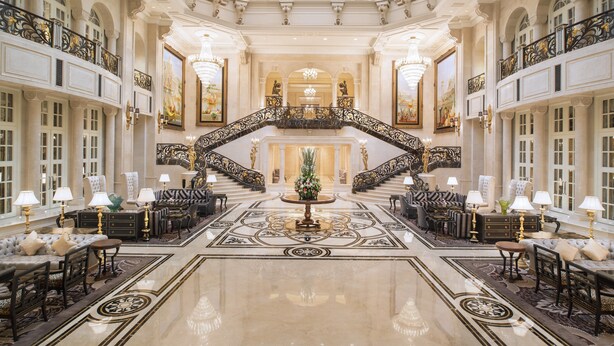 A grand lobby with a high ceiling, ornate staircase, and luxurious furnishings. - The Castle Hotel, a Luxury Collection Hotel, Dalian (Dalian)