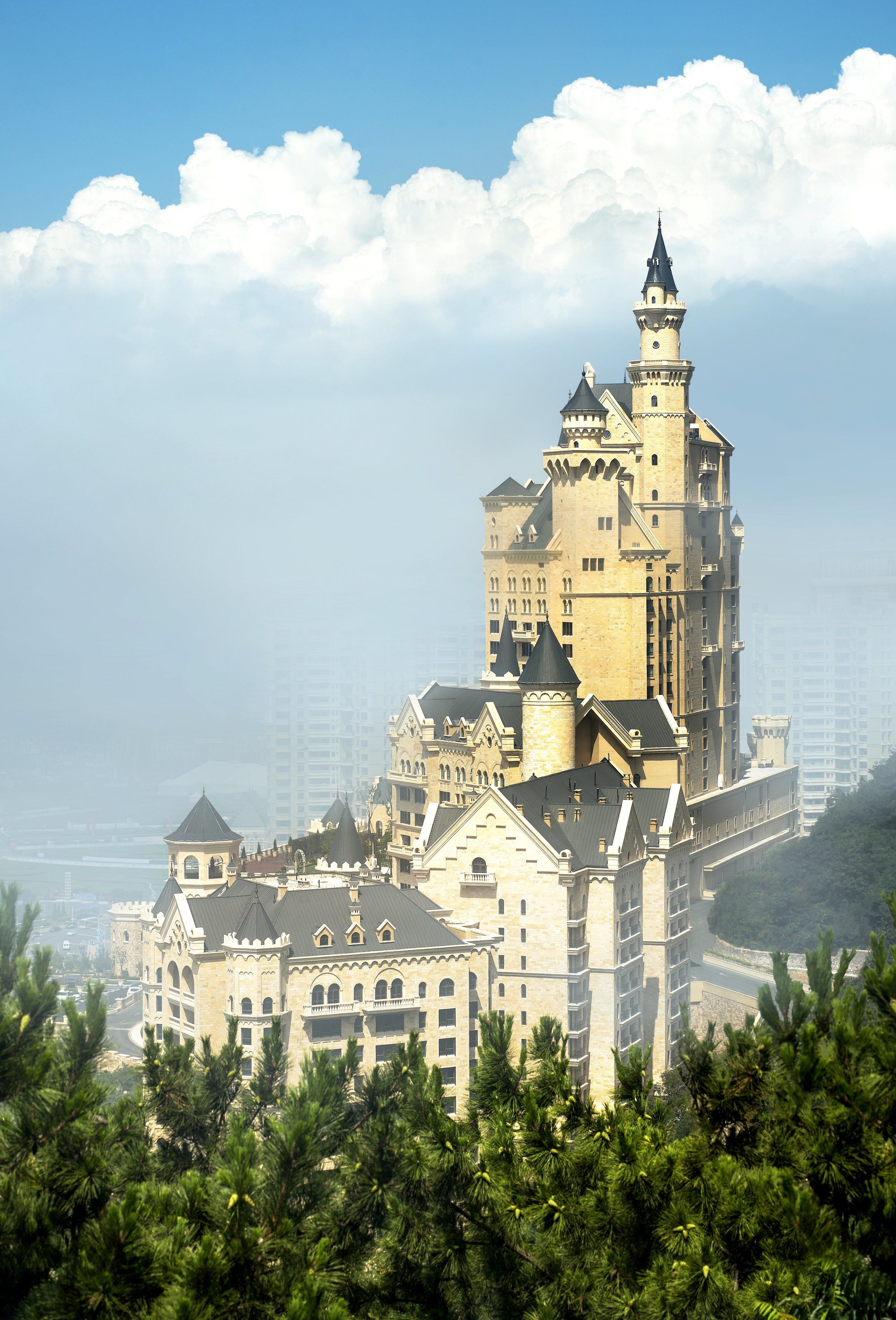 A large, castle-like building with multiple towers and a prominent central tower.