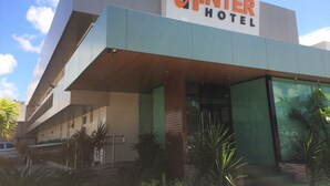The exterior of the Inter Hotel with a modern design, featuring a prominent sign and a glass entrance. - Inter Hotel (Recife)