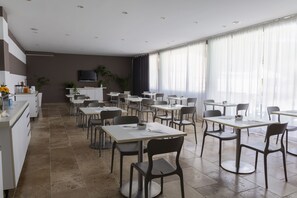 Enjoy meals and casual gatherings in this stylish dining area with flat-screen TV and outdoor views.