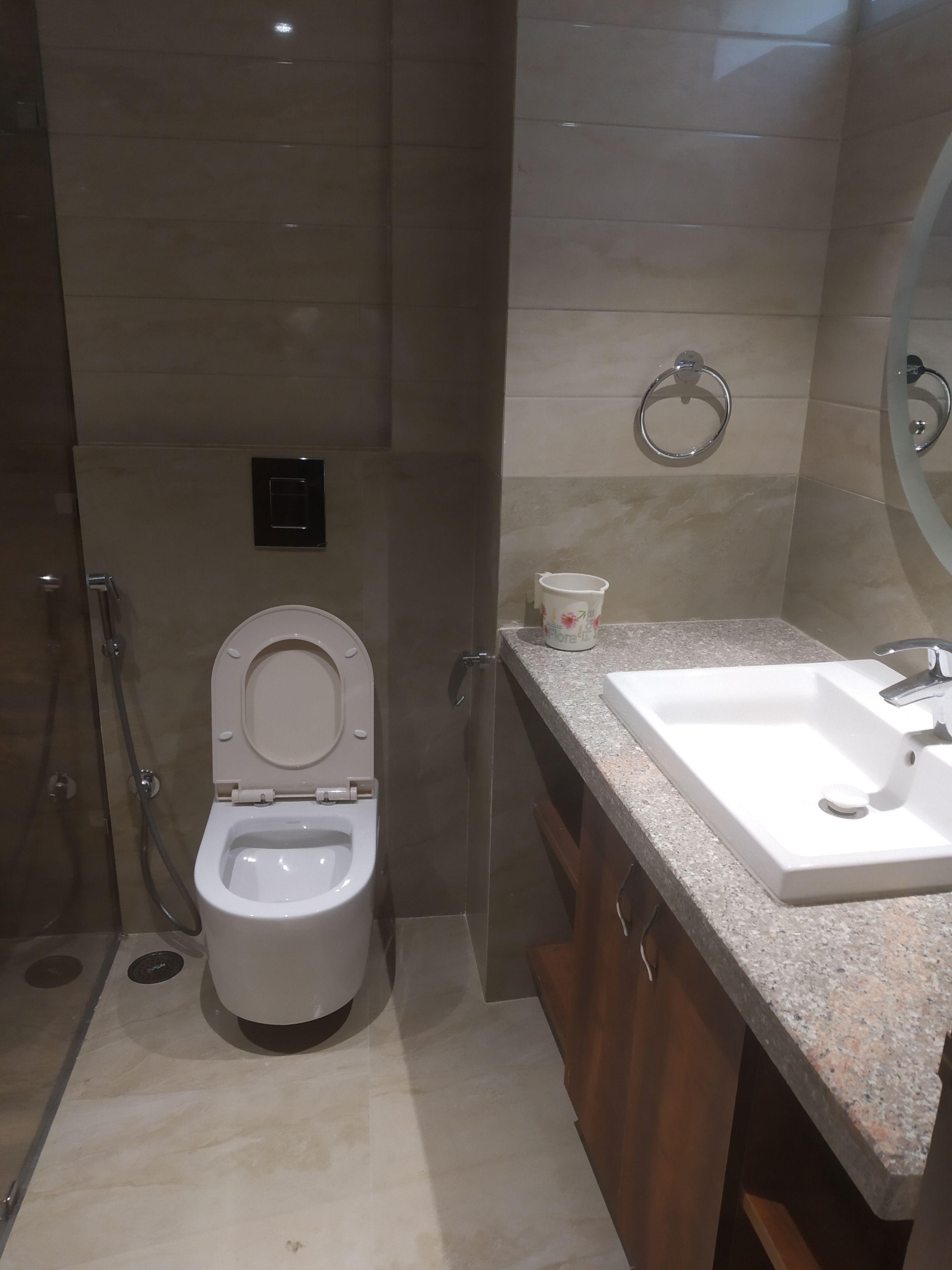 A bathroom with a toilet, sink, and shower.