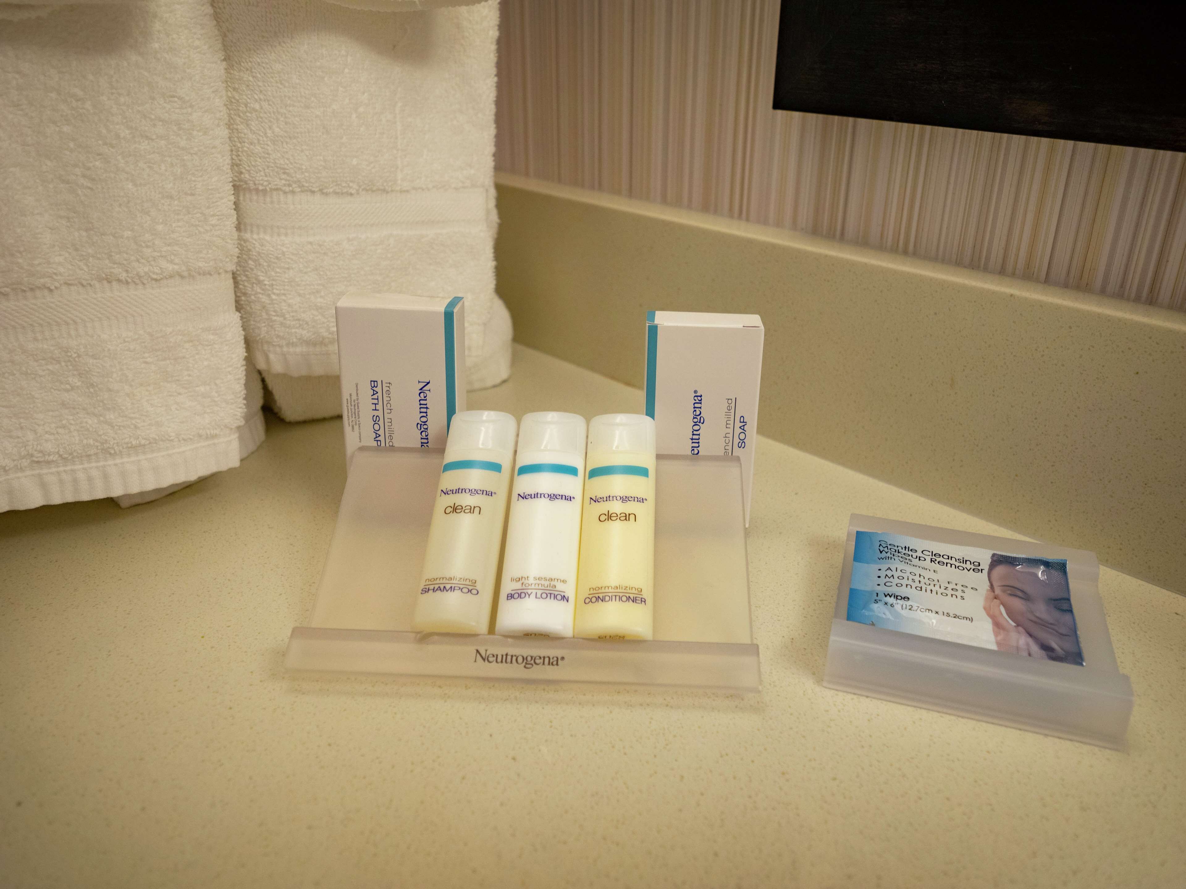 A bathroom counter with Neutrogena products, including shampoo, body lotion, and conditioner.