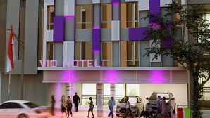 A modern hotel building with a prominent "Veteran" logo and "VID Hotel" signage. - Vio Veteran (Bandung)