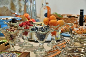 A buffet with various food items including fruits, pastries, and beverages. - Terre di Himera (Termini Imerese)