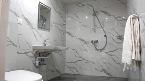 A bathroom with a toilet, sink, and shower. - Aéro Club (Issy-les-Moulineaux)