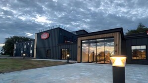 A modern building with a large glass entrance and a sign that reads "Aiden." - Aiden by Best Western Lolland (Holeby)