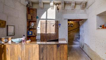 Welcome to the reception area, featuring a wooden desk, a cabinet, and a staircase leading to the upper level.