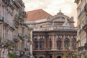 A historic building with ornate architecture, including a prominent dome and statues.