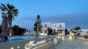 A pool area with a stone floor and a sign reading "Loumis."