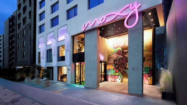 A modern building with a neon sign reading "mosy" and a colorful mural on the facade. - Moxy Seoul Insadong (Seoul)