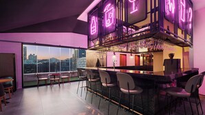 A modern bar area with a high bar counter, multiple seating options, and a city view through large windows. - Moxy Seoul Insadong (Seoul)