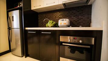 A modern kitchen with a Bosch refrigerator, oven, and toaster.