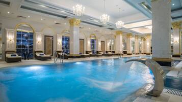 Relax by the pool surrounded by elegant seating and ornate details.