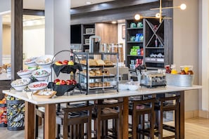 A breakfast buffet with various food items and beverages.