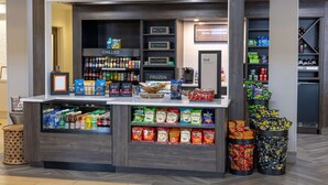 A snack kiosk with a variety of frozen and chilled items, including chips and beverages. - Hilton Garden Inn Roanoke (Roanoke)