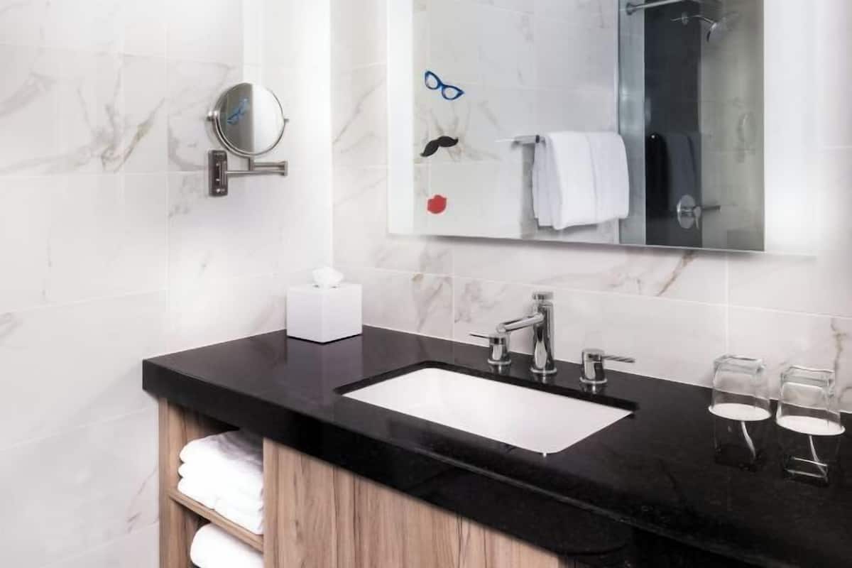 Shower, designer toiletries, hair dryer, towels