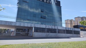 The exterior of the Imperial Plaza Hotel with a large glass facade and a prominent sign. - Imperial Plaza Hotel (Samambaia)
