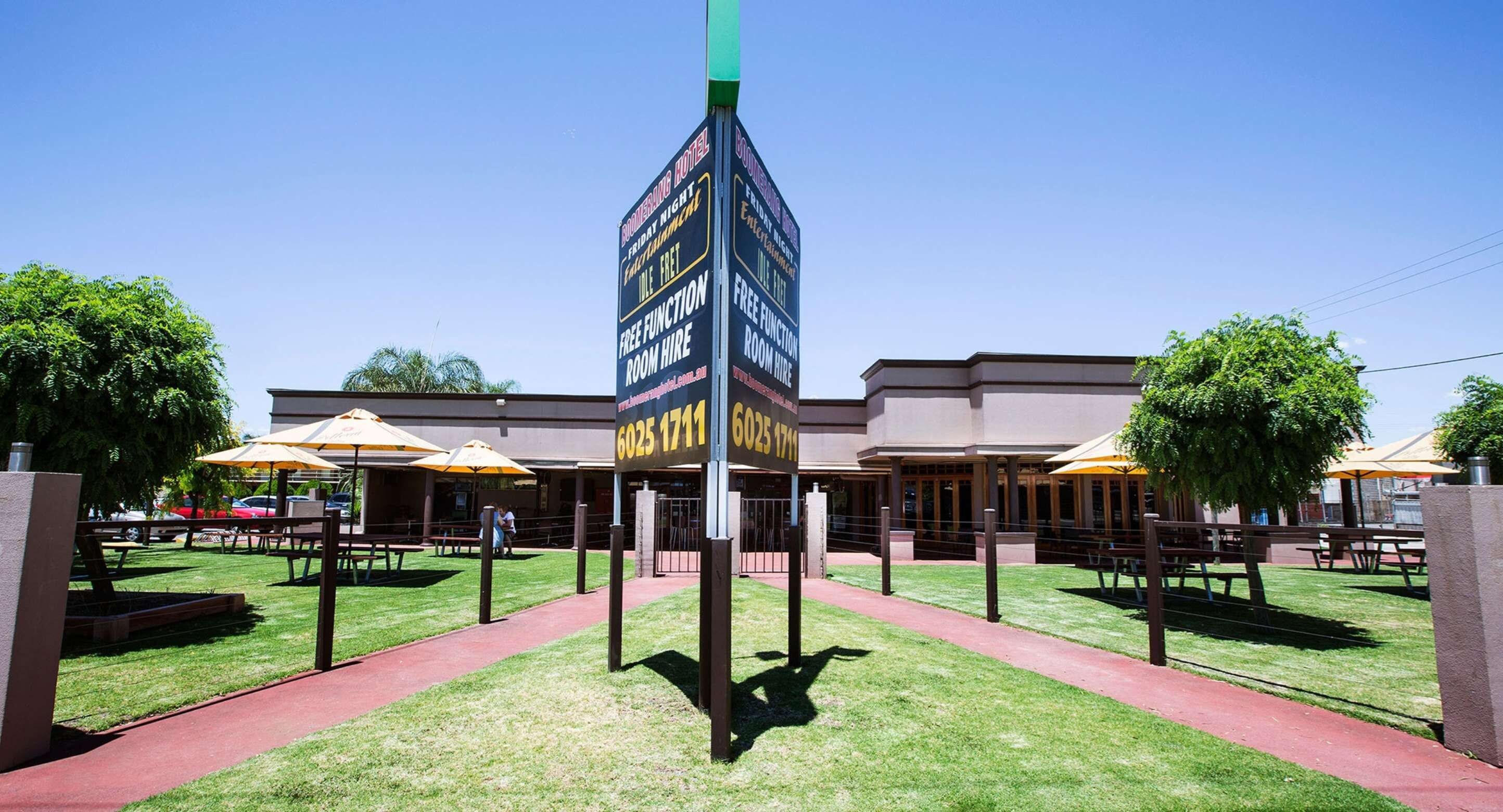 A hotel entrance with a sign advertising free function room hire.