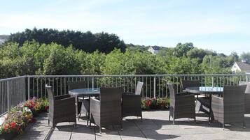 Enjoy al fresco dining and socializing in this charming outdoor space surrounded by lush gardens and scenic views.
