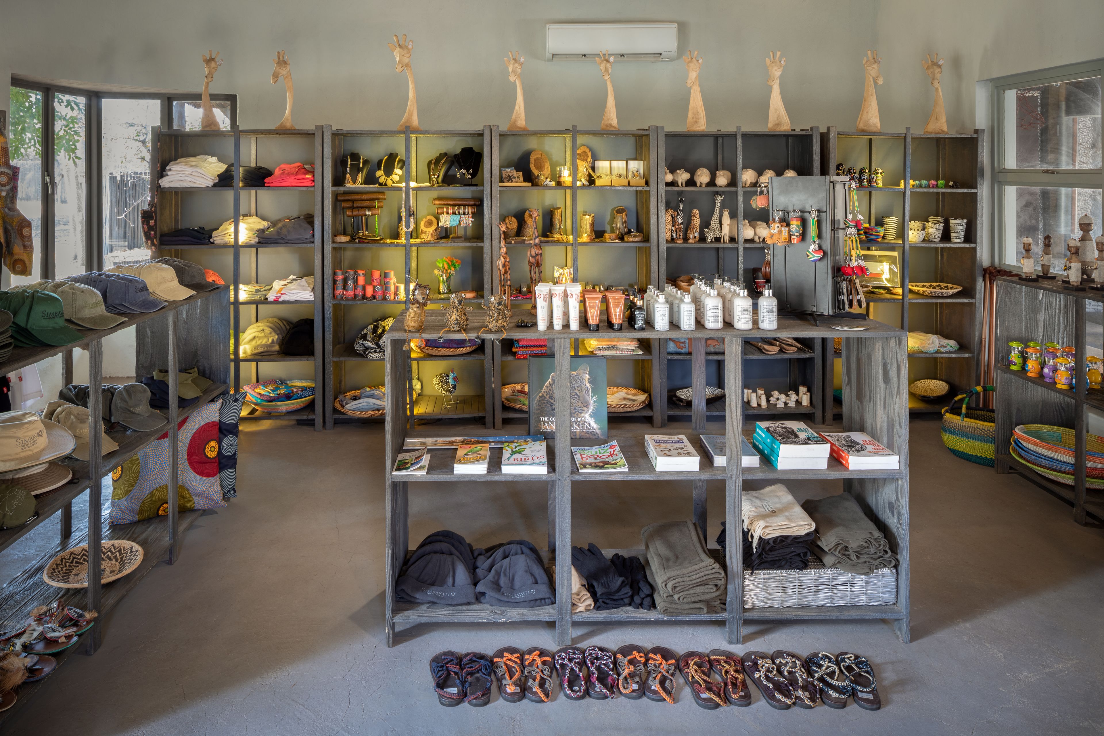 A retail space with shelves stocked with hats, books, and various items.