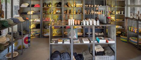 A retail space with shelves stocked with hats, books, and various items.