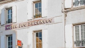 A building with a sign reading "HOTEL DES PYRÉNÉES."