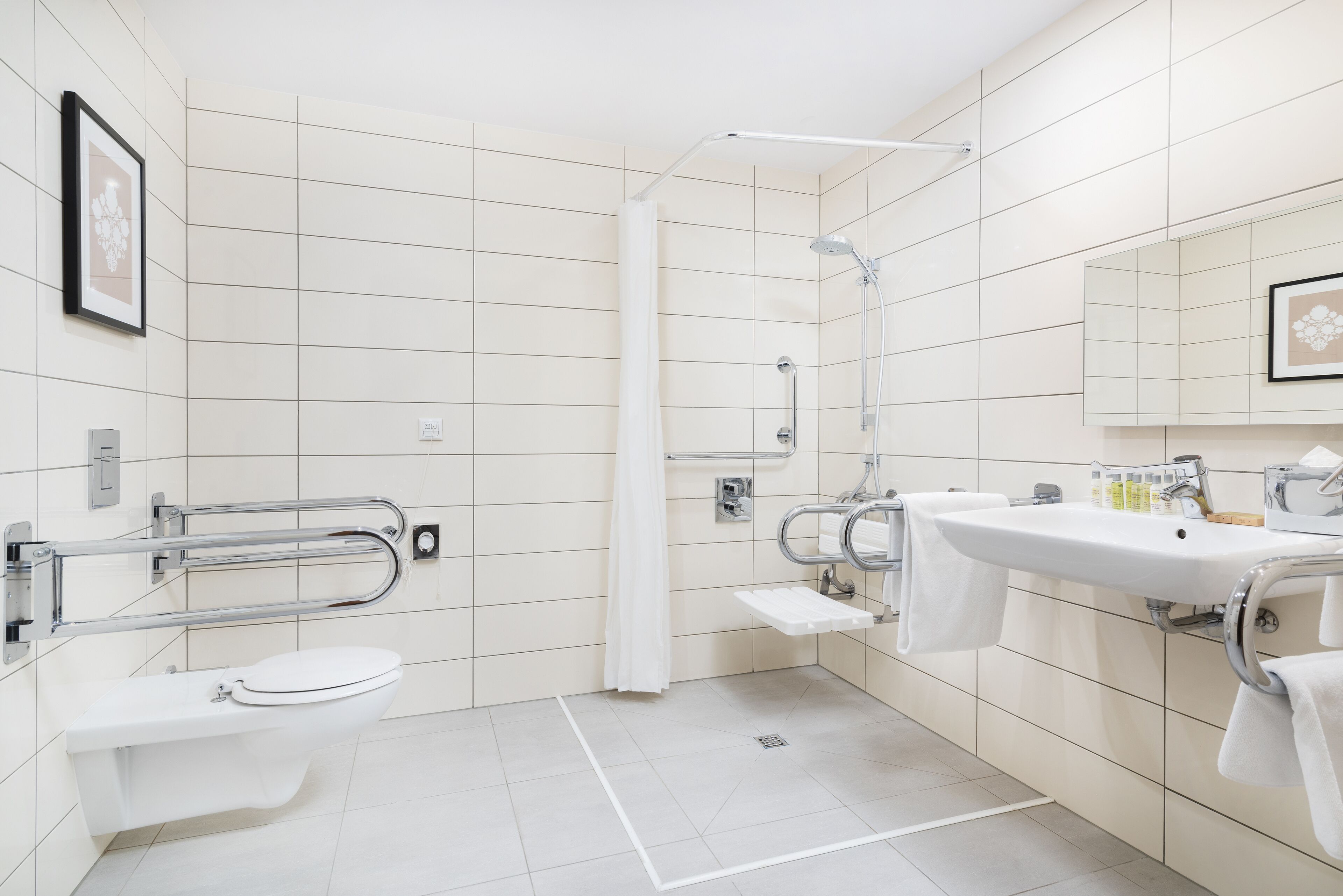 A modern bathroom with a toilet, sink, and shower.