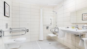 A modern bathroom with a toilet, sink, and shower.
