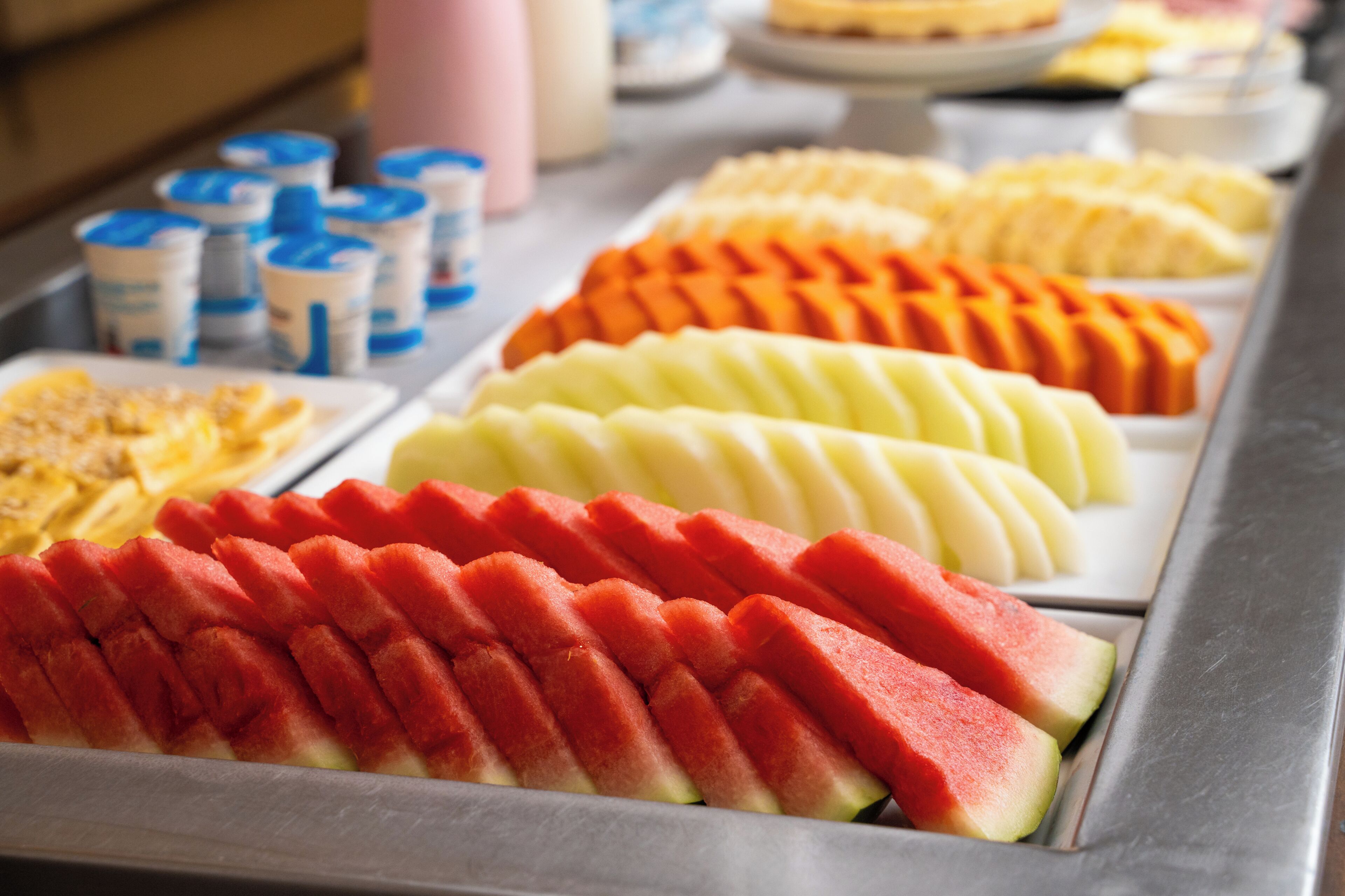 A buffet with various fruits and dairy products.