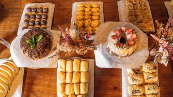A variety of baked goods displayed on a wooden table.