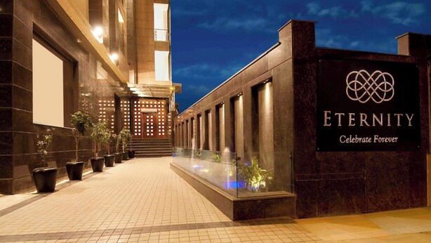 A hotel entrance with a sign reading "ETERNITY Celebrate Forever." - Eternity (New Delhi)