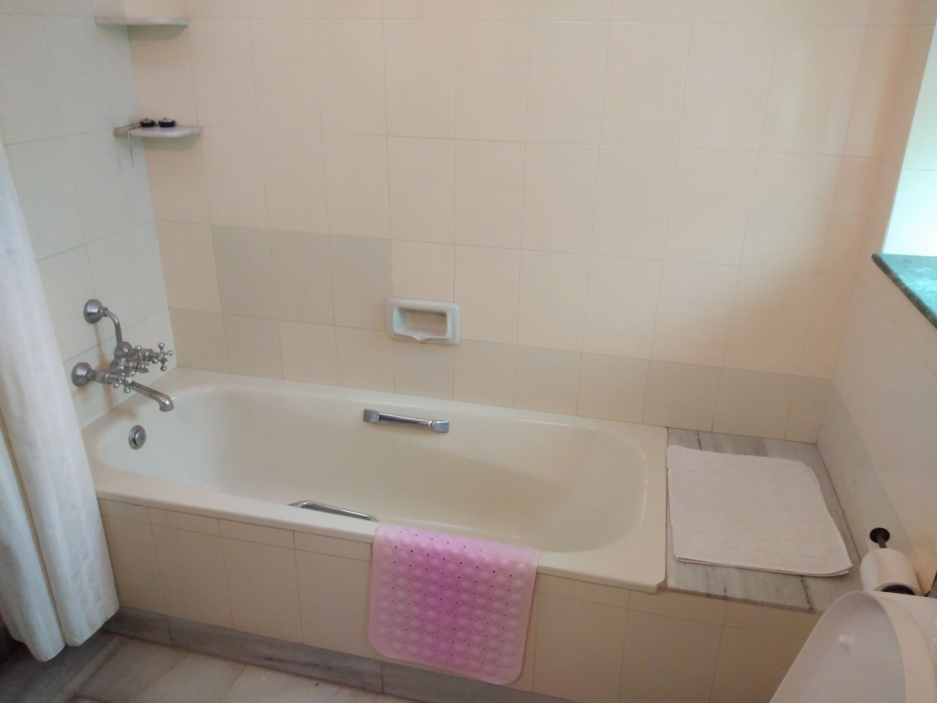 deluxe room (with ac) | bathroom | deep-soaking bathtub, free toiletries, hair dryer, towels