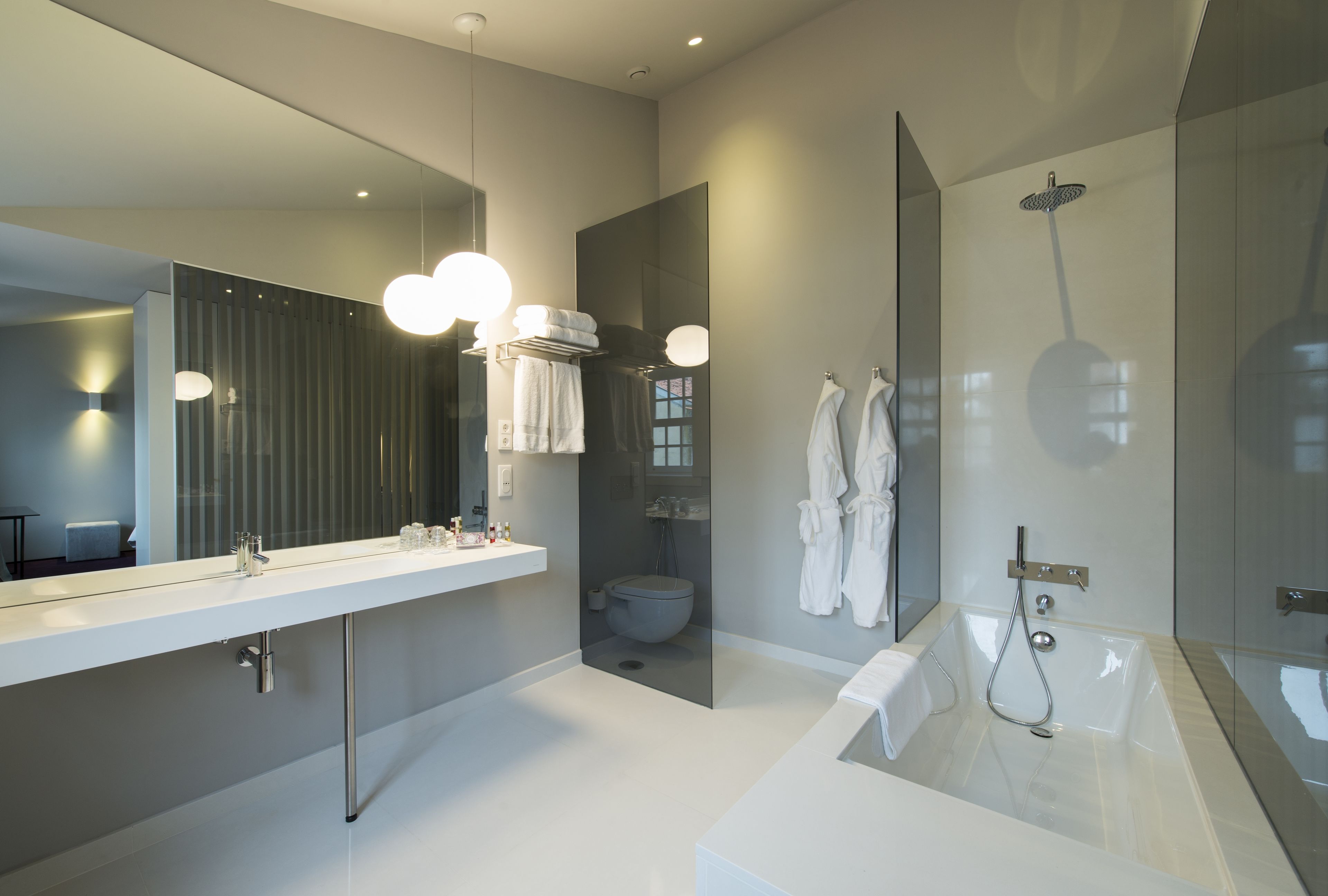 deluxe double room | bathroom | rainfall showerhead, free toiletries, hair dryer, bathrobes