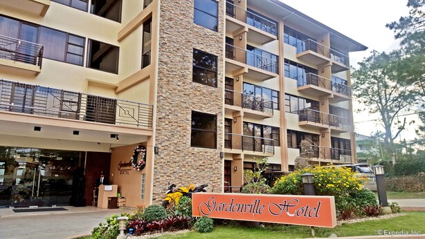 A multi-story hotel with a stone facade, balconies, and a sign reading "Gardenville Hotel". - Gardenville Hotel (Baguio)