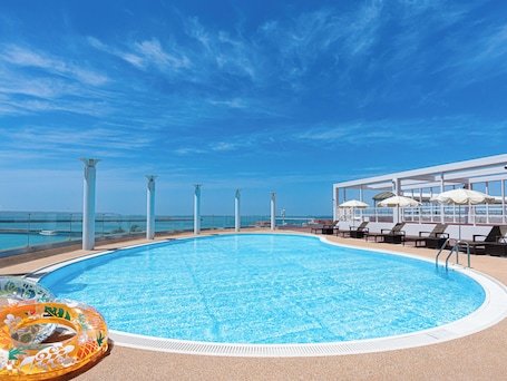 Seasonal outdoor pool, open 8:00 AM to 10:00 PM, pool umbrellas