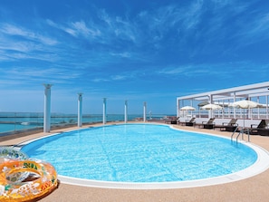 Seasonal outdoor pool, open 8:00 AM to 10:00 PM, pool umbrellas