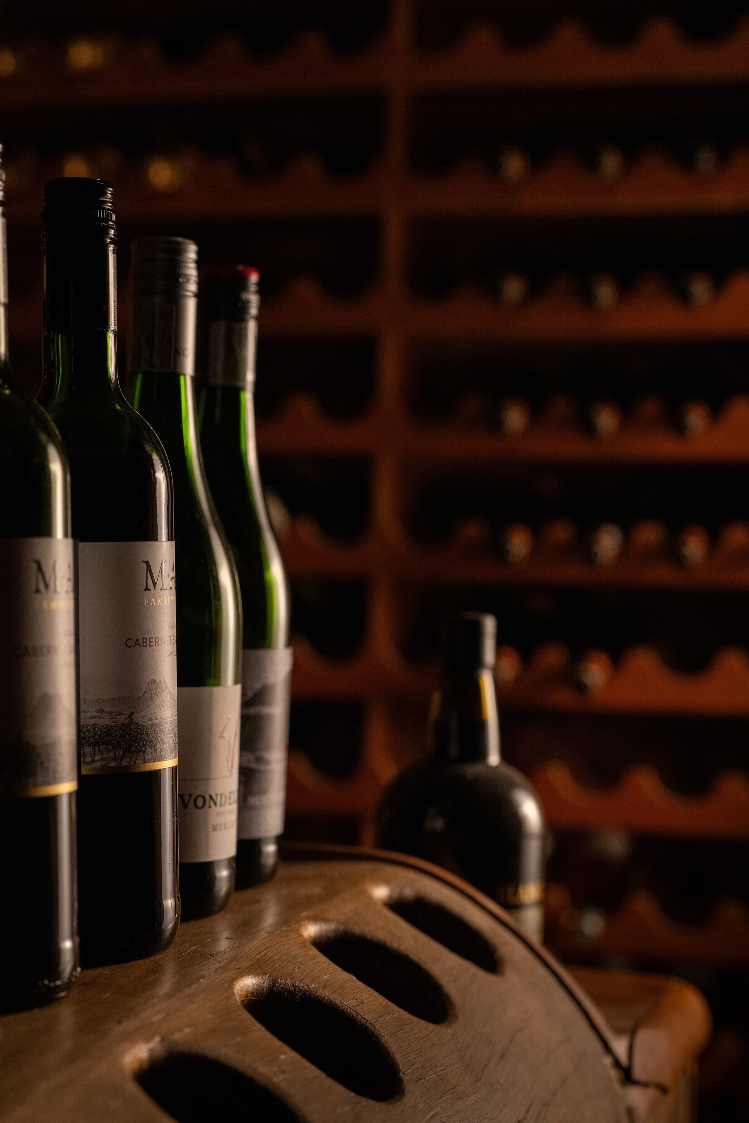 A wooden wine rack with bottles of wine.