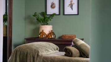 Relax in a serene space with a sofa, potted plant, and framed botanicals.