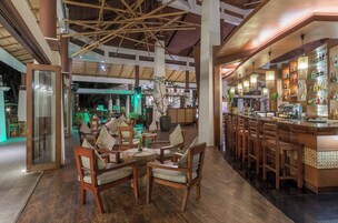 Un área de bar espaciosa con mobiliario de madera y un interior bien iluminado.