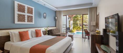 A hotel room with a large bed, a TV, a desk, and a view of the pool area.