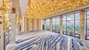 A spacious room with a large window, a patterned carpet, and a ceiling with golden floral decorations. - Princesa Garden Island Resort and Spa (Puerto Princesa)