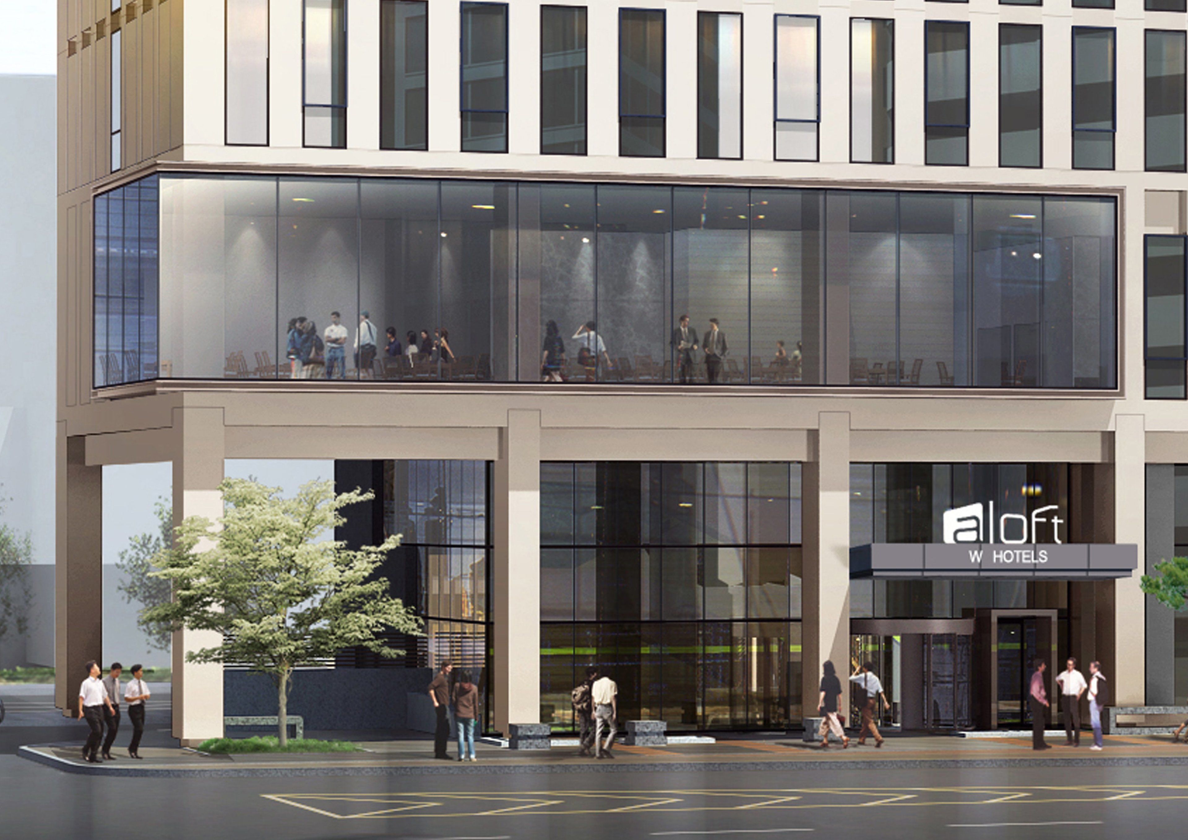 A modern hotel with a glass facade, a prominent 'a loft' sign, and a spacious entrance area.