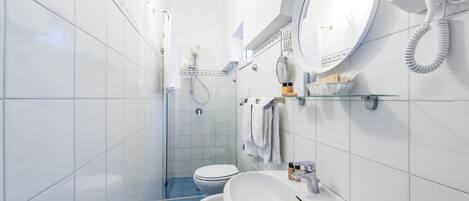 A modern bathroom with a toilet, bidet, and sink.