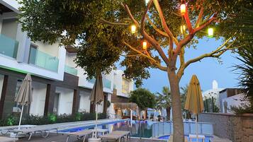 Seasonal outdoor pool, open 8:00 AM to 6:30 PM, pool umbrellas